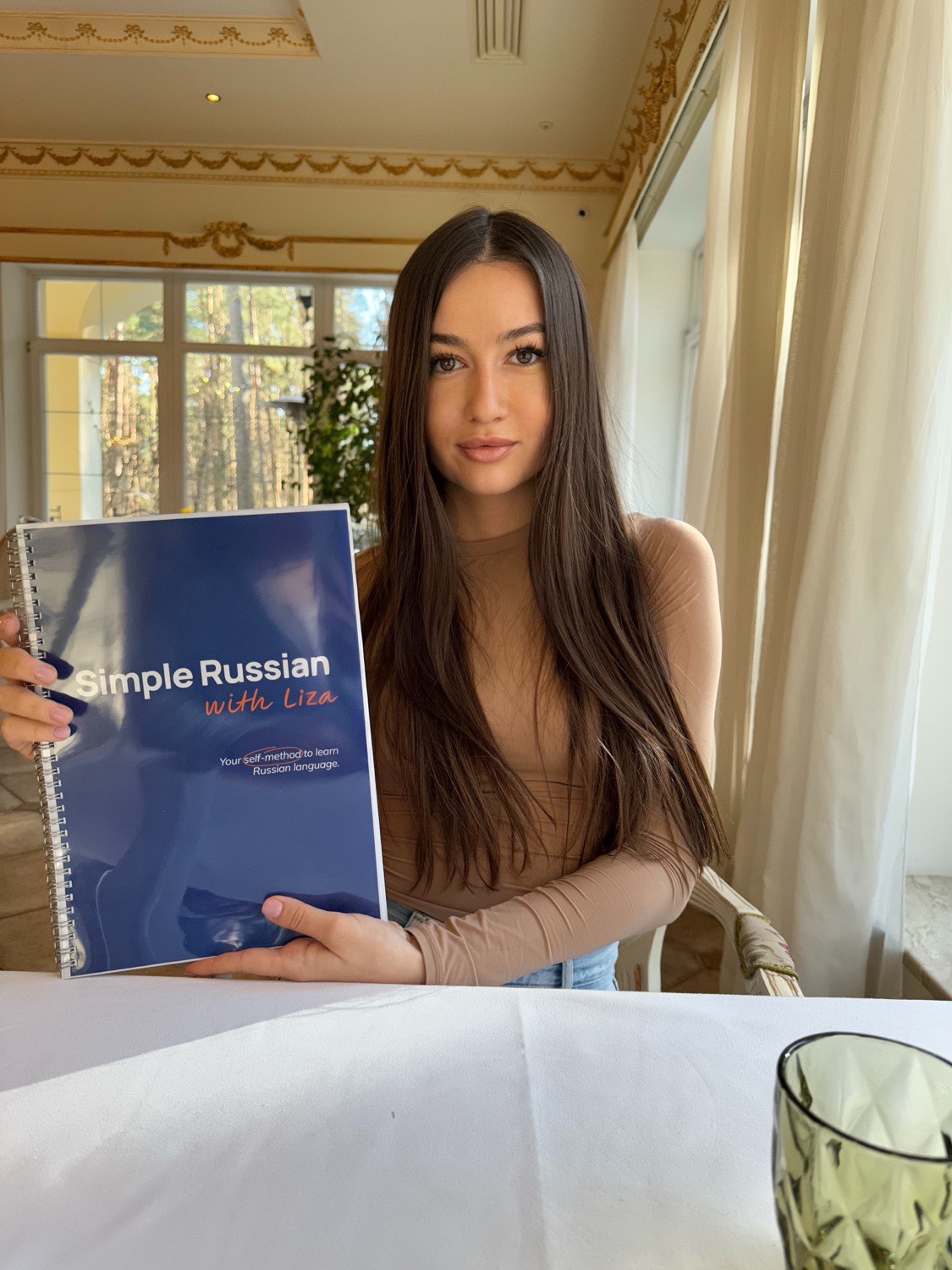 Liza, your Russian teacher, holding the Simple Russian book